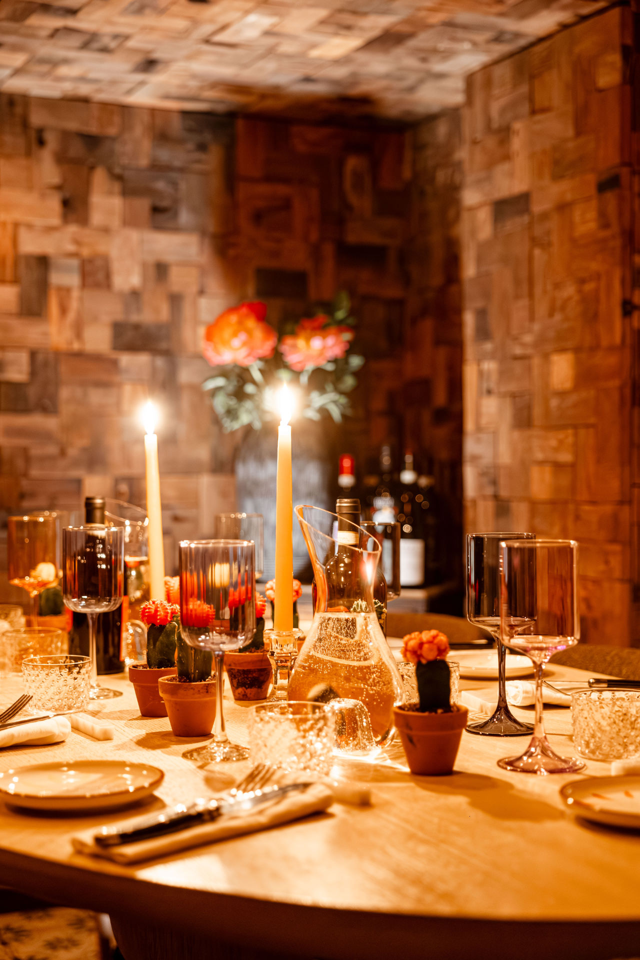 Cellar Be Pasta with table, candles, bottles of wine and dishes